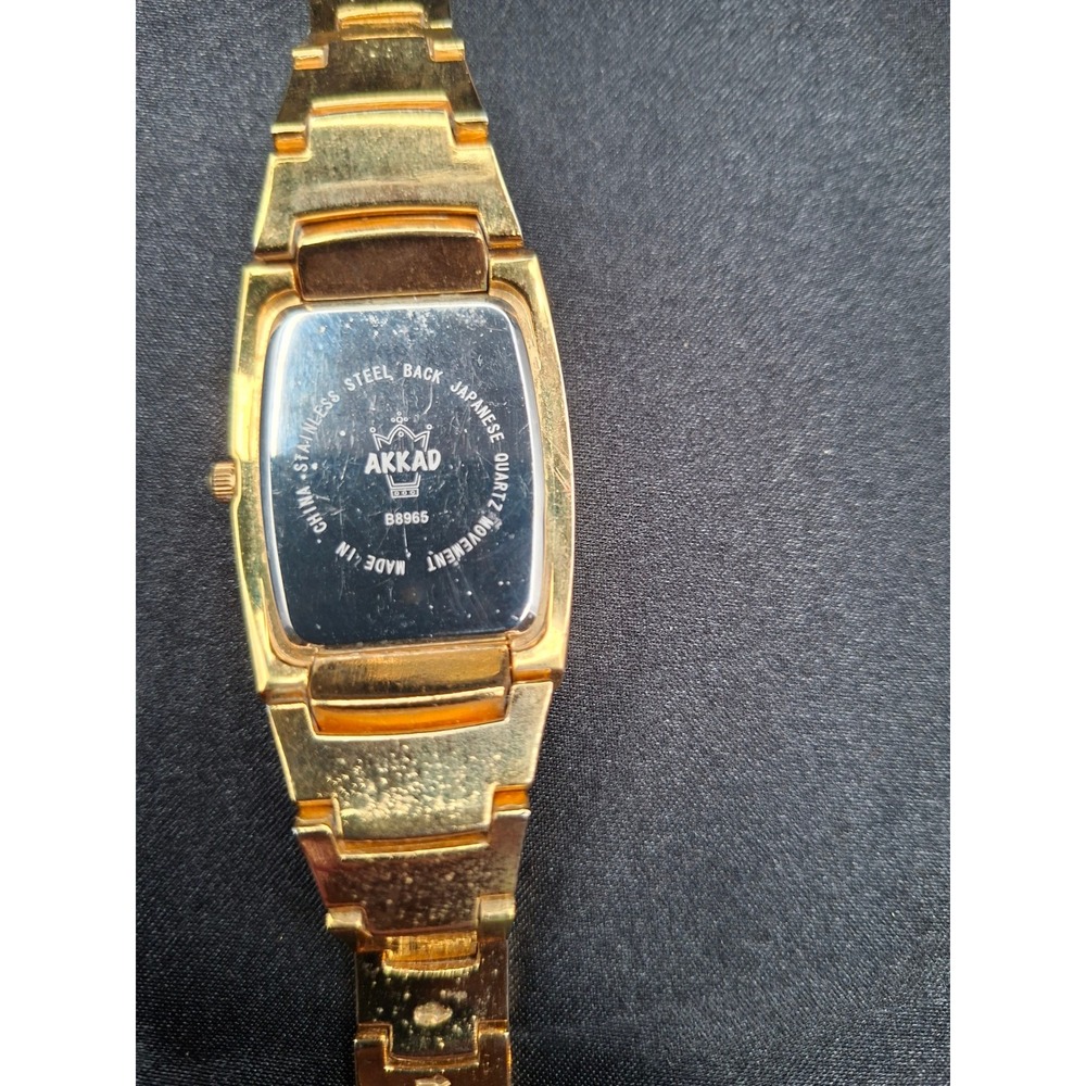 Akkad B8965 Gold Tone Rhinestone Mother of Pearl Roman Numeral Quartz Watch